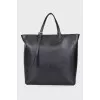 Leather bag with branded accessory