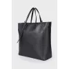 Leather bag with branded accessory
