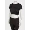 Black top on a zipper with a tag