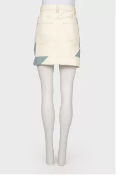 Skirt with geometric inserts with a tag