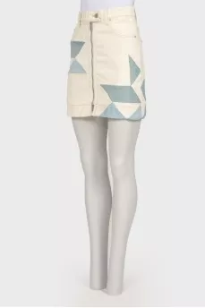 Skirt with geometric inserts with a tag