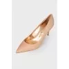 Peach shoes with a shiny coating