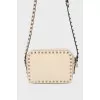 Milk-colored bag with spikes