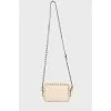 Milk-colored bag with spikes
