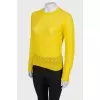 Translucent yellow sweater with a tag