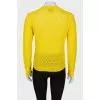 Translucent yellow sweater with a tag