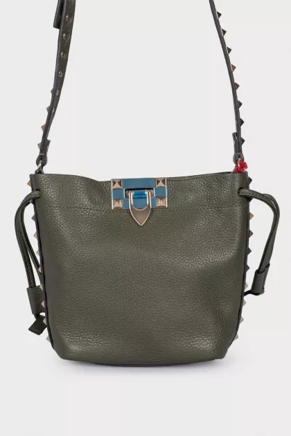 Green studded bag with tag