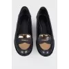 Loofers with a golden metal toe