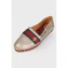 Golden slip-ons with branded appliqué