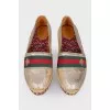 Golden slip-ons with branded appliqué