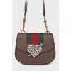 Bag with appliqué and wide strap