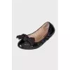 Black patent ballerinas with a large bow