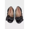 Black patent ballerinas with a large bow