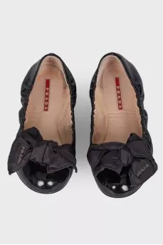 Black patent ballerinas with a large bow