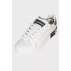 Sneakers with a large logo on the heel