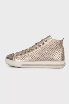 Golden sneakers in metal rhinestones