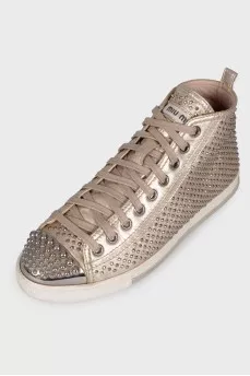 Golden sneakers in metal rhinestones