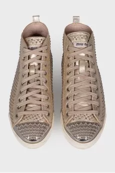 Golden sneakers in metal rhinestones