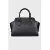 Leather bag with keychain and branded patch