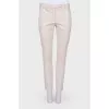 Compressed beige pants with arrows
