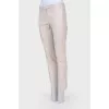 Compressed beige pants with arrows