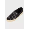 Black slip-on shoes with spikes