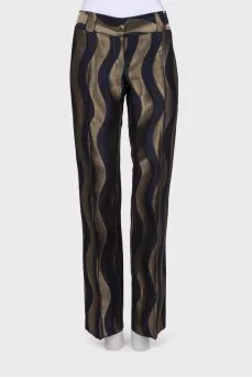 Black trousers in golden print with tag