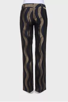 Black trousers in golden print with tag