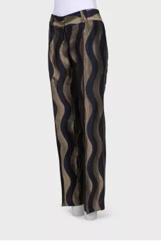 Black trousers in golden print with tag