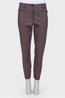 Gray trousers with zippers on pockets