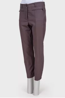 Gray trousers with zippers on pockets