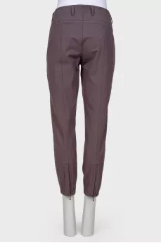 Gray trousers with zippers on pockets
