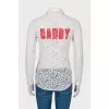 Lace blouse with slogan on the back