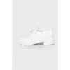 White loafers with triangular brand logo
