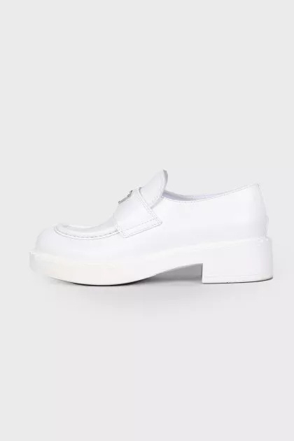 White loafers with triangular brand logo