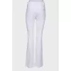 White flared trousers with tag