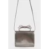 Silver bag with a bow on the handle