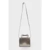 Silver bag with a bow on the handle