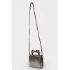 Silver bag with a bow on the handle
