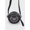 Round bag with metal decoration