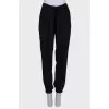 Black trousers with a bow at the waist