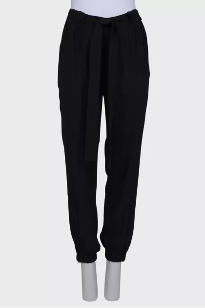 Black trousers with a bow at the waist
