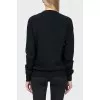 Black sweater with a big yellow smiley face