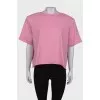 Pink T-shirt with shoulder pads and tag