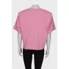 Pink T-shirt with shoulder pads and tag