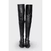 Leather over the knee boots with a strap