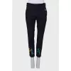 Blue trousers with colored eyelets
