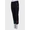 Blue trousers with colored eyelets