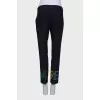 Blue trousers with colored eyelets
