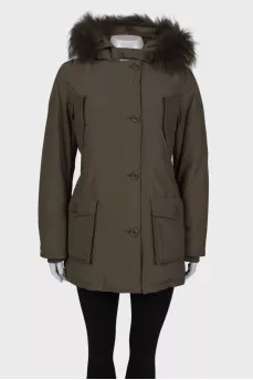 Green parka with fur on the hood with a tag